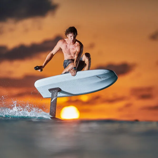 eFoil rider jumping over water during sunset