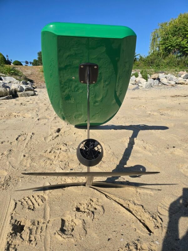 Rear view of a custom green electric hydrofoil eFoil board with foil mast, propulsion system, and hydrofoil wings on the sand at Buckroe Beach in Hampton, Virginia.