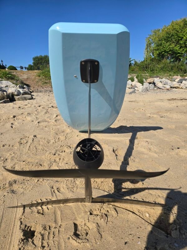 Rear view of a light blue electric hydrofoil eFoil board with foil wings and propulsion system on the sand at Buckroe Beach in Hampton, Virginia.