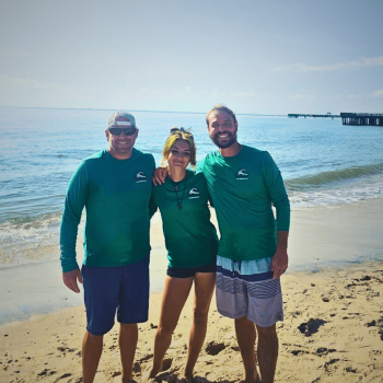 Three Green Wave staff smiling on Buckroe Beach